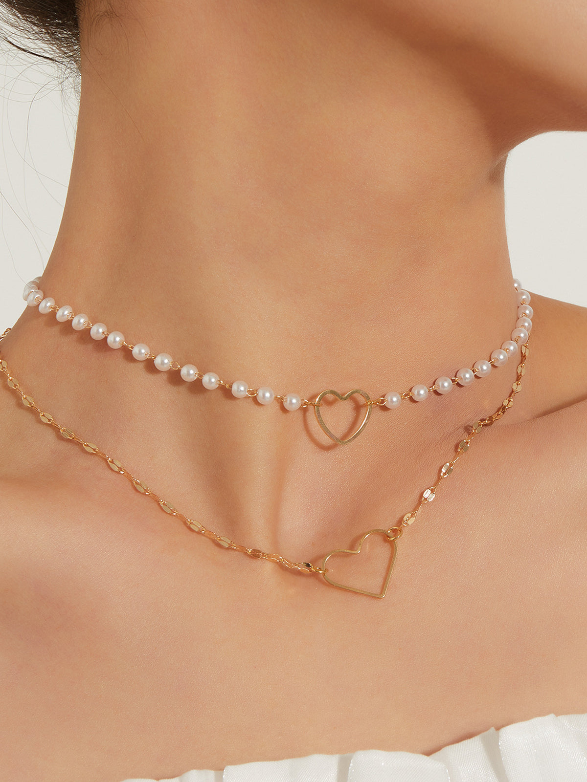 Dubbel laag oorbellen met hart en parels - Elegante en verfijnde ketting